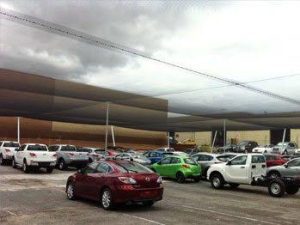 Automotive anti hail netting shielding parked cars from hailstones impact